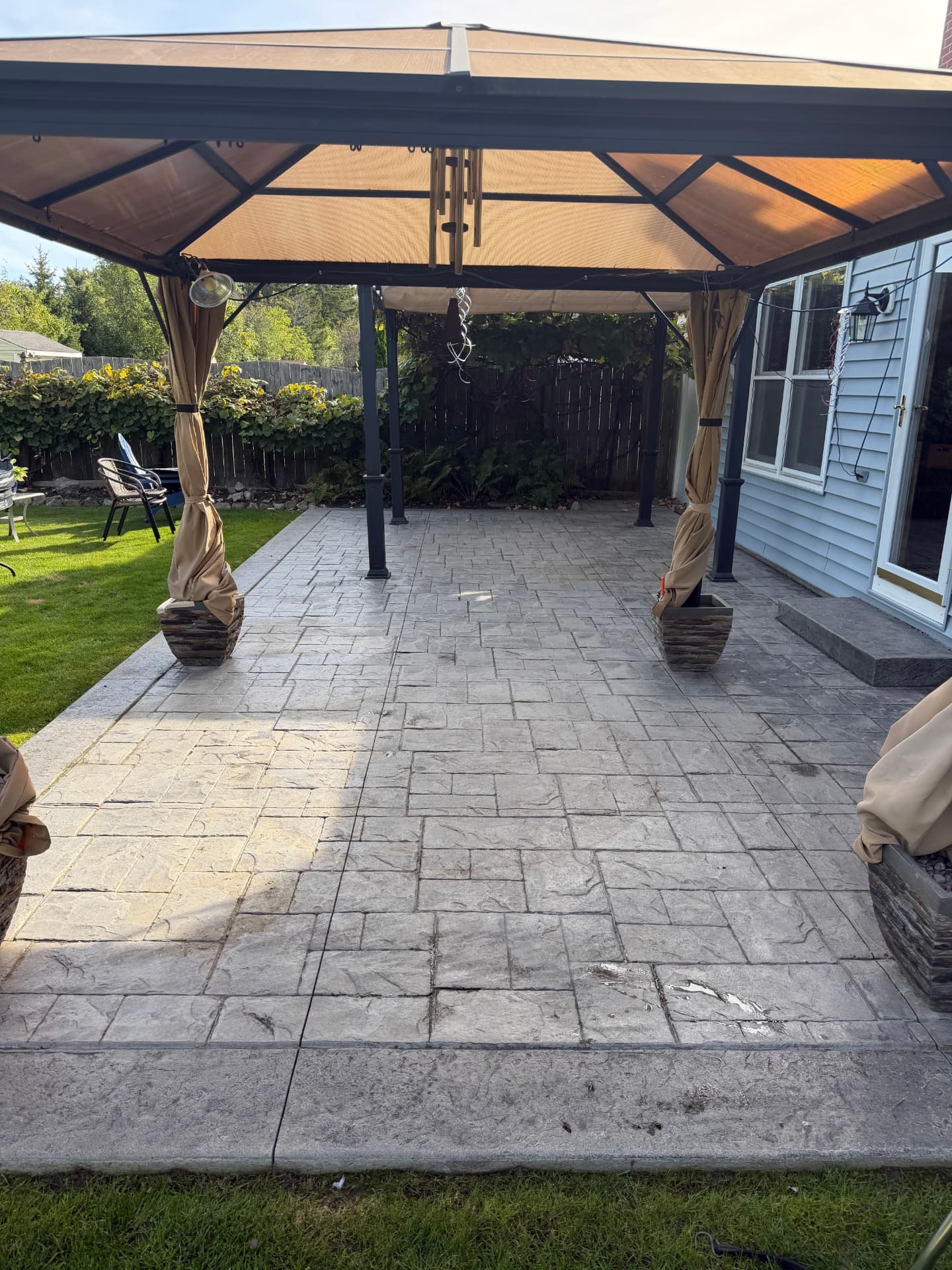 Before — stamped concrete pergola patio washed, re-colored and sealed