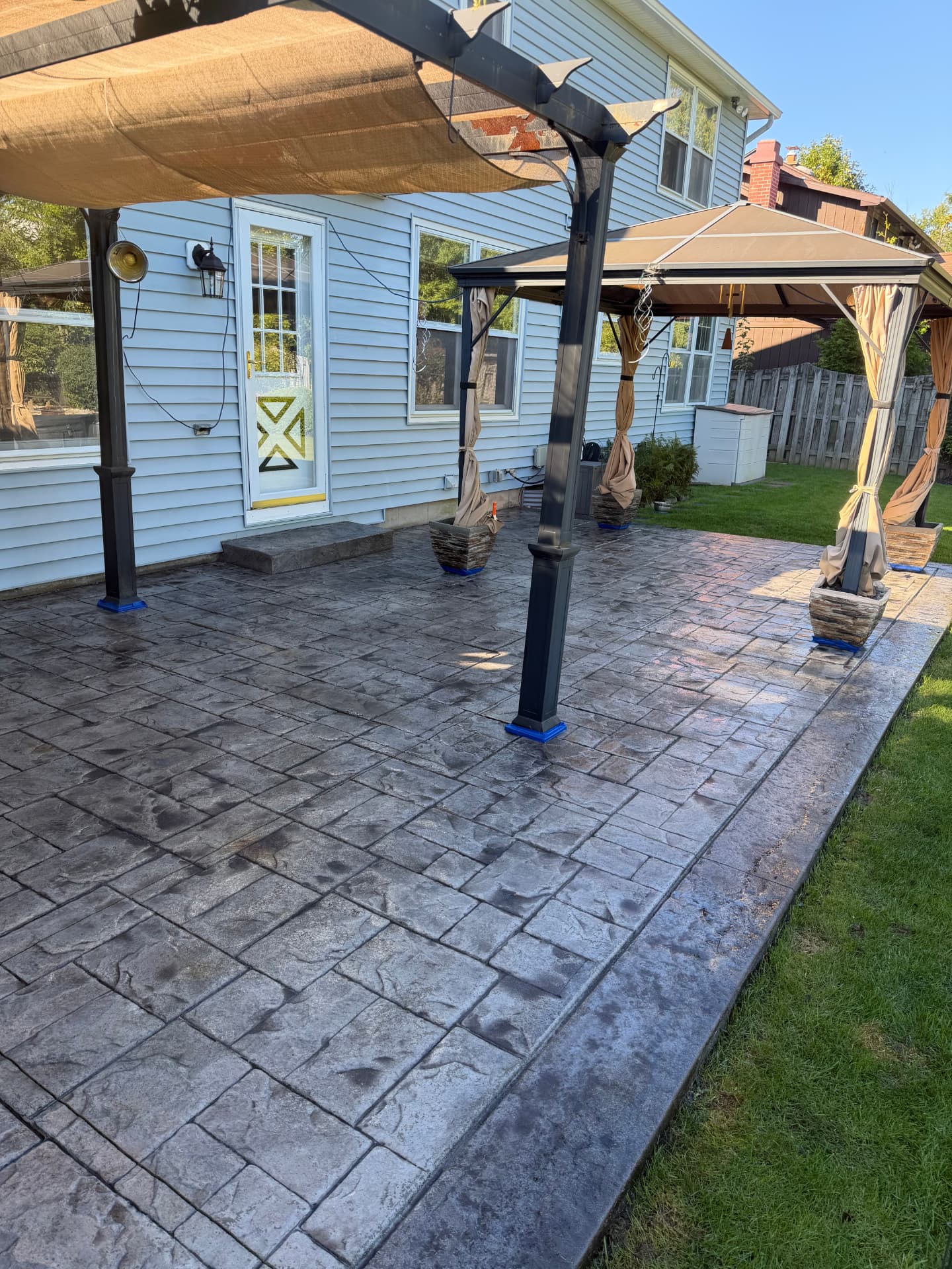 After — stamped concrete pergola patio washed, re-colored and sealed