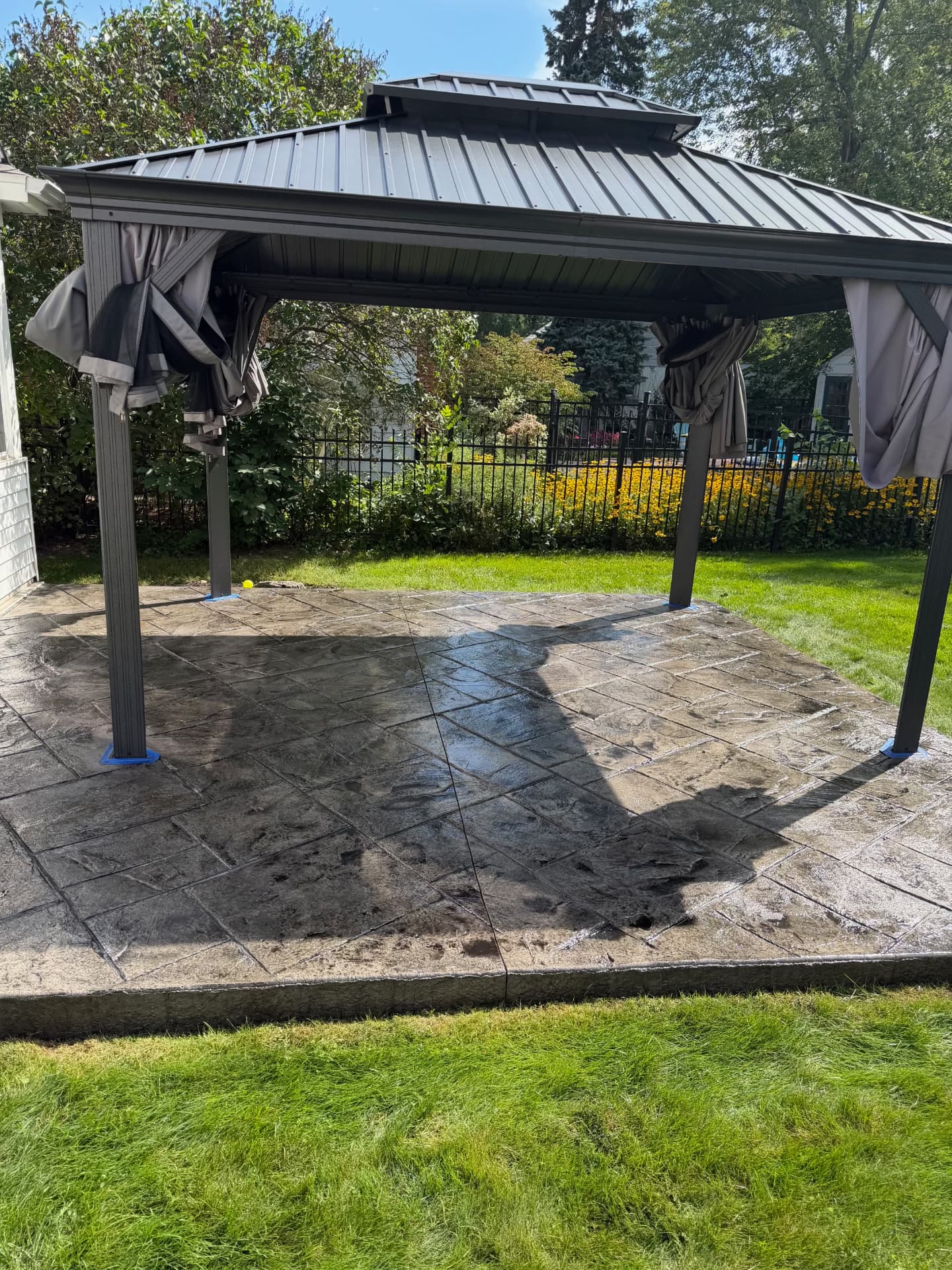 After — stamped concrete patio under a gazebo washed, re-colored and sealed