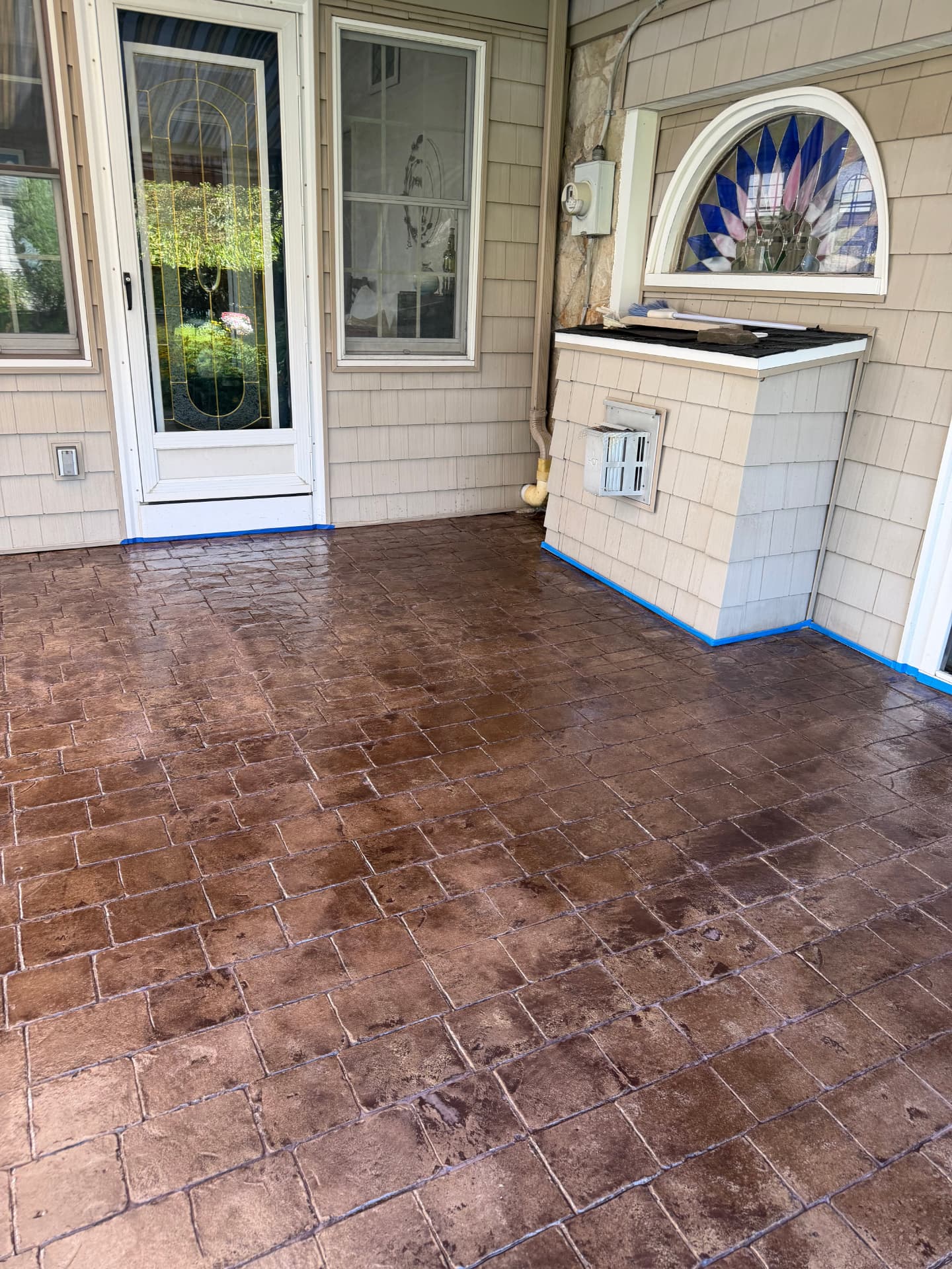 After — stamped concrete covered porch washed, re-colored and sealed